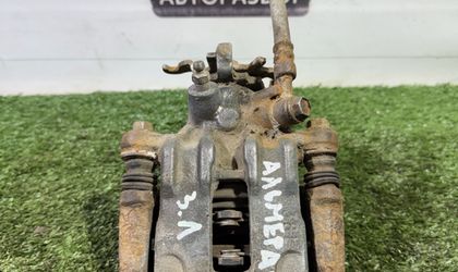 Суппорт тормозной задний левый Nissan Almera N16
